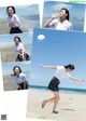 A woman in a school uniform is dancing on the beach.