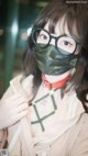 A woman wearing a mask and glasses.