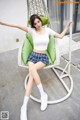 a woman sitting on a chair with her arms outstretched